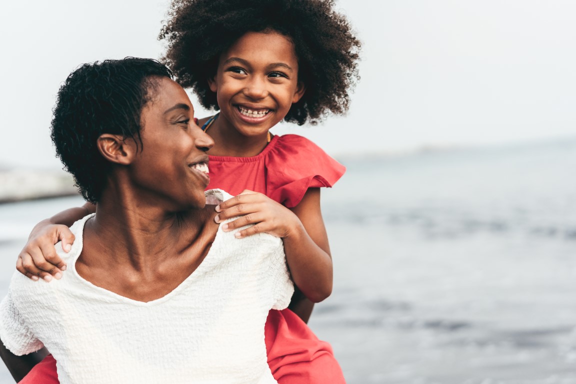 african mother and daughter running on the beach a 2022 02 17 18 22 20 utc